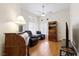 Comfortable bedroom with hardwood floors, a ceiling fan, and window for natural light at 7828 Morning Flower Ln, Las Vegas, NV 89129