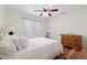 Bright bedroom with hardwood floors, ceiling fan, and closet for ample storage space at 7828 Morning Flower Ln, Las Vegas, NV 89129