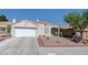 Single story home featuring desert landscaping and a spacious two-car garage at 7828 Morning Flower Ln, Las Vegas, NV 89129