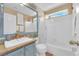 Bright bathroom with a bathtub-shower combo, framed mirror, and ample counter space at 7845 Scammons Bay Ct, Las Vegas, NV 89129