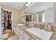 Bright bathroom with double sinks, granite counters, and a walk-in closet with plenty of storage at 7845 Scammons Bay Ct, Las Vegas, NV 89129