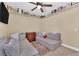 Casual bedroom featuring multiple comfortable seating surfaces, shelving and a TV at 7845 Scammons Bay Ct, Las Vegas, NV 89129