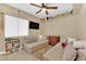 Cozy bedroom with a small TV, built in shelving, window and casual seating at 7845 Scammons Bay Ct, Las Vegas, NV 89129