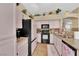 Bright kitchen featuring black appliances, bright cabinets, and granite countertops at 7845 Scammons Bay Ct, Las Vegas, NV 89129