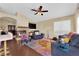 Cozy living room with modern ceiling fan, stylish decor, and fireplace to create a relaxed atmosphere at 7845 Scammons Bay Ct, Las Vegas, NV 89129