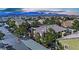 Aerial view of residential complex with tiled roofs, mature trees, and ample parking with mountain views at 7950 W Flamingo Rd # 1044, Las Vegas, NV 89147