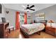 Spacious bedroom with stylish decor, a dark ceiling fan, and wooden floors at 7950 W Flamingo Rd # 1044, Las Vegas, NV 89147