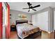 Bright bedroom featuring a modern ceiling fan, ample closet space, and wooden floors at 7950 W Flamingo Rd # 1044, Las Vegas, NV 89147