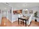 Charming dining room features a modern chandelier, hardwood floors, and comfortable seating for four at 7950 W Flamingo Rd # 1044, Las Vegas, NV 89147