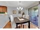 Charming dining room features a modern chandelier, hardwood floors, and comfortable seating for four at 7950 W Flamingo Rd # 1044, Las Vegas, NV 89147
