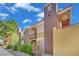 Beautiful two-story condo with manicured landscaping, balconies, and a stucco exterior under a blue sky at 7950 W Flamingo Rd # 1044, Las Vegas, NV 89147