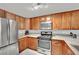 Modern kitchen featuring stainless steel refrigerator, range, and wooden cabinets at 7950 W Flamingo Rd # 1044, Las Vegas, NV 89147