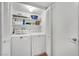 Convenient laundry room equipped with washer, dryer, and ample shelving at 7950 W Flamingo Rd # 1044, Las Vegas, NV 89147