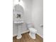 This half bathroom has tile floors, a pedestal sink and neutral colors at 8117 Discovery Point St, Las Vegas, NV 89139