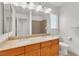 Bright bathroom with double sinks, granite counters, and wooden cabinets at 8117 Discovery Point St, Las Vegas, NV 89139