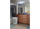 Bathroom with a glass-enclosed shower, tile floors, and vanity with wood cabinets, blending style with practicality at 8117 Discovery Point St, Las Vegas, NV 89139