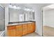 Bright bathroom with double sinks, granite counters, and wooden cabinets at 8117 Discovery Point St, Las Vegas, NV 89139