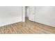 Bright bedroom with light laminate flooring, white walls, and a white door at 8117 Discovery Point St, Las Vegas, NV 89139