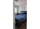 Comfortable bedroom with wood floors, featuring a bed, window, and closet, designed for rest and relaxation at 8117 Discovery Point St, Las Vegas, NV 89139