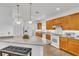 Spacious kitchen with granite countertop island, oak cabinets, and modern appliances at 8117 Discovery Point St, Las Vegas, NV 89139
