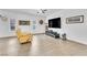 Bright living room featuring wood-look tile floors, a ceiling fan, and a neutral color palette at 8117 Discovery Point St, Las Vegas, NV 89139