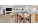Open-concept living and dining area with tile floors, white walls, and bright, natural light at 8117 Discovery Point St, Las Vegas, NV 89139