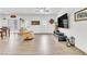 Bright living room featuring wood-look tile floors, a ceiling fan, and a neutral color palette at 8117 Discovery Point St, Las Vegas, NV 89139