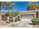 Well-maintained home with desert landscaping, a two-car garage, and a quaint gated entrance at 8628 Desert Holly Dr, Las Vegas, NV 89134