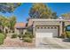 Attractive single-story home with a red tile roof and a two-car garage with decorative windows at 8628 Desert Holly Dr, Las Vegas, NV 89134
