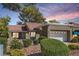Charming home with a red tile roof, manicured landscaping, and an attached two-car garage at 8628 Desert Holly Dr, Las Vegas, NV 89134