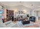 Comfortable living room with open floor plan, wood floors, cozy seating, and natural light at 8628 Desert Holly Dr, Las Vegas, NV 89134