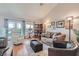 Bright living room boasts wood floors, large windows, comfortable seating, and stylish decor at 8628 Desert Holly Dr, Las Vegas, NV 89134