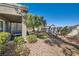Private backyard featuring a covered patio, mature landscaping, and desert-friendly ground cover at 8628 Desert Holly Dr, Las Vegas, NV 89134
