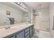 Bathroom featuring a double sink vanity, large mirror, and glass-enclosed shower at 8628 Desert Holly Dr, Las Vegas, NV 89134