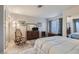 Serene bedroom featuring wood floors, neutral tones, and a comfortable rocking chair at 8628 Desert Holly Dr, Las Vegas, NV 89134