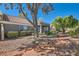 Exterior view of a well-maintained townhome with covered patio and lush landscaping at 8628 Desert Holly Dr, Las Vegas, NV 89134