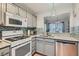 Bright kitchen featuring granite countertops, stainless steel appliances, and view to dining area at 8628 Desert Holly Dr, Las Vegas, NV 89134