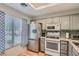 Well-lit kitchen with stainless steel appliances, gray cabinets, and a mosaic tile backsplash at 8628 Desert Holly Dr, Las Vegas, NV 89134