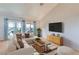 Bright living room with vaulted ceilings, neutral decor, and ample natural light from the sliding glass doors at 8628 Desert Holly Dr, Las Vegas, NV 89134