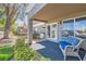 Charming covered patio with outdoor seating and meticulously landscaped backyard at 8628 Desert Holly Dr, Las Vegas, NV 89134