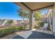 Charming covered patio with seating area and lush landscaping at 8628 Desert Holly Dr, Las Vegas, NV 89134
