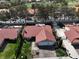 Aerial view of home with a tile roof, desert landscaping, and mature trees at 8641 Surtidor Dr, Las Vegas, NV 89117