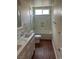 Bathroom with dual sink vanity, white cabinets, bathtub-shower with marble-like tile at 8641 Surtidor Dr, Las Vegas, NV 89117