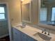 Bathroom featuring double vanity, white cabinets, marble countertop and two large framed mirrors at 8641 Surtidor Dr, Las Vegas, NV 89117