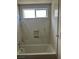Bathroom featuring a bathtub and shower with marble-like tiling and a shower niche at 8641 Surtidor Dr, Las Vegas, NV 89117