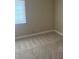 Neutral bedroom with wall-to-wall carpeting and a window at 8641 Surtidor Dr, Las Vegas, NV 89117