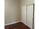 Neutral bedroom with double sliding door closet and wood floors at 8641 Surtidor Dr, Las Vegas, NV 89117