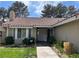 Charming front entrance features a tile roof, well-maintained landscaping and inviting walkway at 8641 Surtidor Dr, Las Vegas, NV 89117