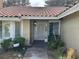 Charming front entrance features a tile roof, well-maintained landscaping and inviting walkway at 8641 Surtidor Dr, Las Vegas, NV 89117