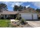 Inviting home features a two-car garage, desert landscaping, and tile roof at 8641 Surtidor Dr, Las Vegas, NV 89117